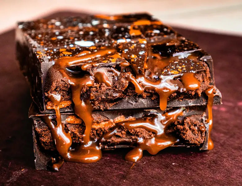 A Stone Grindz STUFFT bar broken open, caramel running down its layers