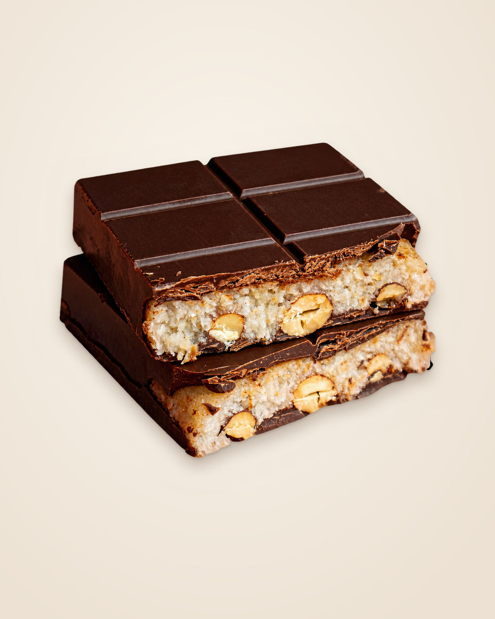 Coconut Almond Dream STUFFT bar, broken open to show the toasted coconut filling and whole roasted almonds