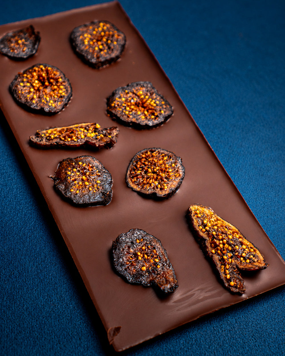 Vanilla Fig 90% dark chocolate bar topped with sliced dried black mission figs, shown at an angle