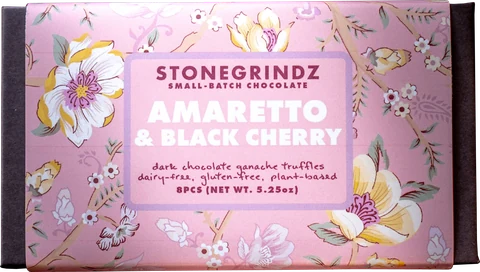 Cherry Amaretto dark chocolate ganache truffles, one cut open to show the ganache
